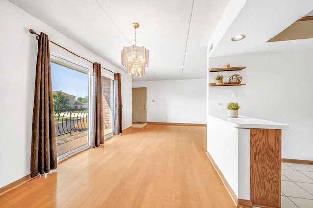 16719 Paxton Ave Unit 2S, Tinley Park, IL 60477 - unfurnished dining area with a chandelier and light wood-style floors