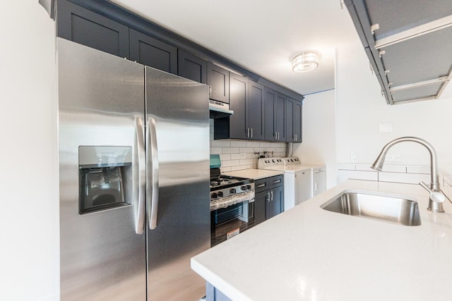 407 James Ct Unit D, Glendale Heights, IL 60139 - kitchen with appliances with stainless steel finishes, washing machine and clothes dryer, under cabinet range hood, backsplash, and light countertops