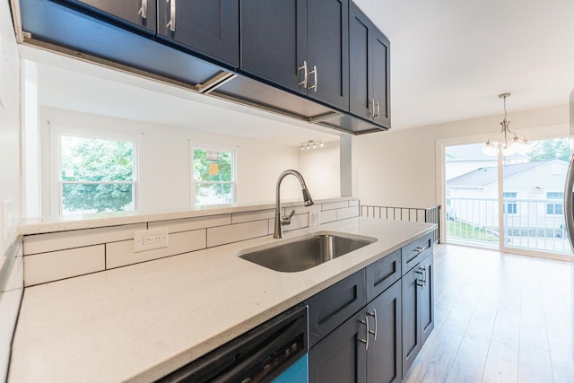 407 James Ct Unit D, Glendale Heights, IL 60139 - kitchen featuring light stone counters, dishwashing machine, pendant lighting, light wood-style flooring, and a chandelier