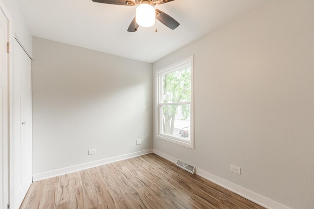 407 James Ct Unit D, Glendale Heights, IL 60139 - unfurnished bedroom with wood finished floors, a ceiling fan, and a closet