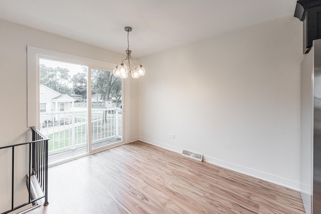 407 James Ct Unit D, Glendale Heights, IL 60139 - spare room with light wood finished floors and a chandelier