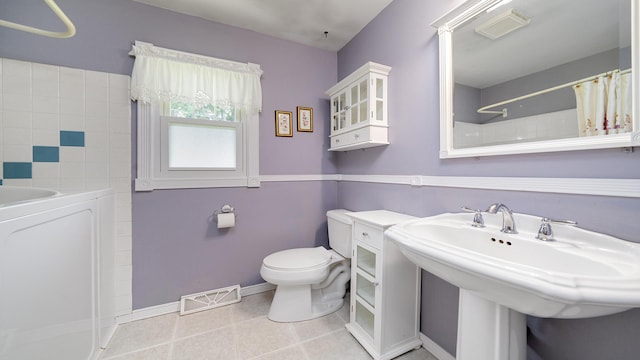 9833 Gentian Dr, Machesney Park, IL 61115 - bathroom with washer / clothes dryer, a shower with shower curtain, and tile patterned floors