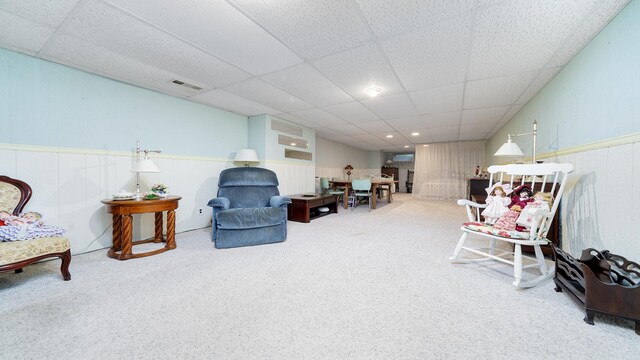 9833 Gentian Dr, Machesney Park, IL 61115 - living area with carpet, a paneled ceiling, and wainscoting