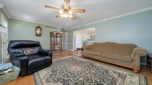 9833 Gentian Dr, Machesney Park, IL 61115 - living area featuring wood finished floors, a ceiling fan, and ornamental molding