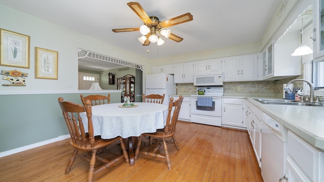 9833 Gentian Dr, Machesney Park, IL 61115 - kitchen featuring white appliances, light countertops, white cabinetry, backsplash, and light wood finished floors