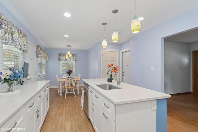 3513 Woodland Cir, Island Lake, IL 60042 - kitchen with light wood-type flooring, white cabinets, light countertops, stainless steel dishwasher, and recessed lighting