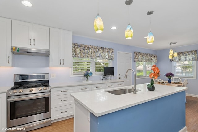 3513 Woodland Cir, Island Lake, IL 60042 - kitchen with stainless steel gas range, under cabinet range hood, light wood-style flooring, white cabinetry, and recessed lighting