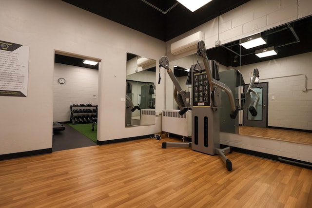 3550 N Lake Shore Dr Unit 2616, Chicago, IL 60657 - exercise room with a wall mounted air conditioner, wood finished floors, and radiator