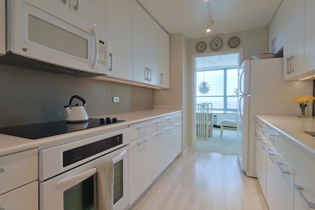 3550 N Lake Shore Dr Unit 2616, Chicago, IL 60657 - kitchen with white appliances, white cabinets, light wood finished floors, and light countertops