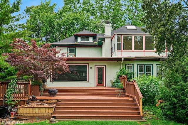 311 3rd St, Wilmette, IL 60091 - view of front of home featuring a chimney, stucco siding, and a deck