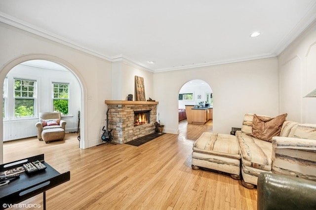 311 3rd St, Wilmette, IL 60091 - living area featuring arched walkways, light wood finished floors, ornamental molding, a fireplace, and recessed lighting
