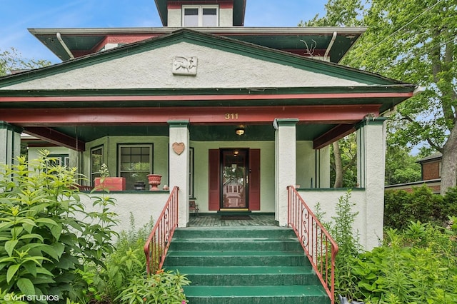 311 3rd St, Wilmette, IL 60091 - property entrance featuring covered porch and stucco siding