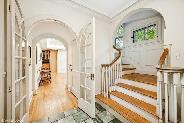 311 3rd St, Wilmette, IL 60091 - foyer with french doors, arched walkways, crown molding, and stairs