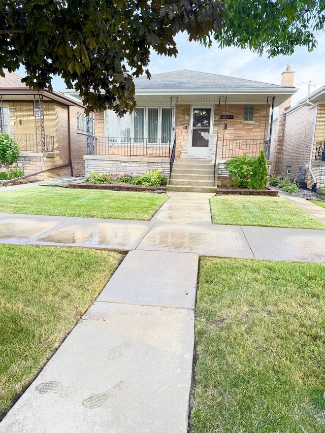 6023 W 64th St, Chicago, IL 60638 - bungalow-style house with covered porch and a front yard