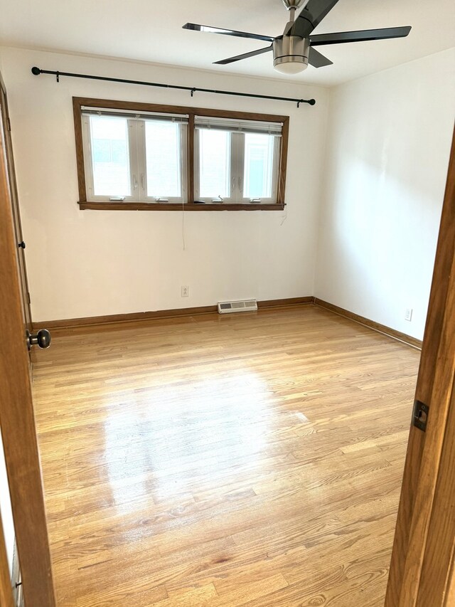 6023 W 64th St, Chicago, IL 60638 - unfurnished room featuring a ceiling fan and light wood-style flooring