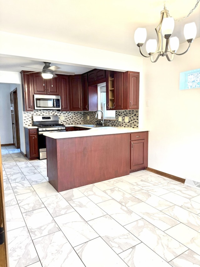 6023 W 64th St, Chicago, IL 60638 - kitchen featuring stainless steel appliances, light marble finish flooring, a peninsula, decorative backsplash, and a chandelier