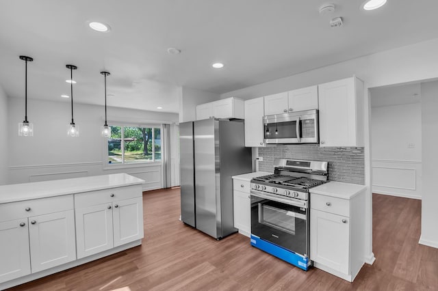 246 Gentry St, Park Forest, IL 60466 - kitchen featuring stainless steel appliances, light countertops, light wood-type flooring, white cabinets, and recessed lighting