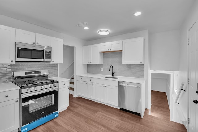 246 Gentry St, Park Forest, IL 60466 - kitchen with appliances with stainless steel finishes, light countertops, white cabinets, decorative backsplash, and recessed lighting