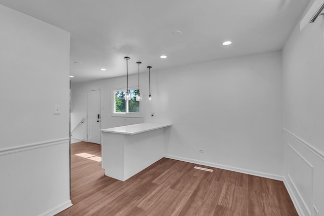 246 Gentry St, Park Forest, IL 60466 - kitchen featuring wood finished floors, decorative light fixtures, recessed lighting, a peninsula, and light countertops