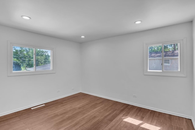 246 Gentry St, Park Forest, IL 60466 - empty room with healthy amount of natural light, wood finished floors, and recessed lighting