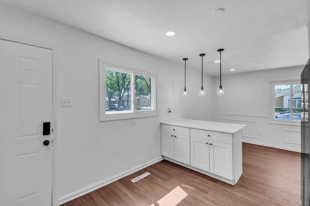 246 Gentry St, Park Forest, IL 60466 - kitchen featuring a peninsula, white cabinetry, plenty of natural light, wood finished floors, and recessed lighting