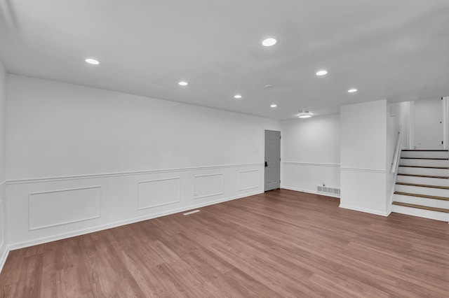 246 Gentry St, Park Forest, IL 60466 - basement with stairs, recessed lighting, wood finished floors, wainscoting, and a decorative wall