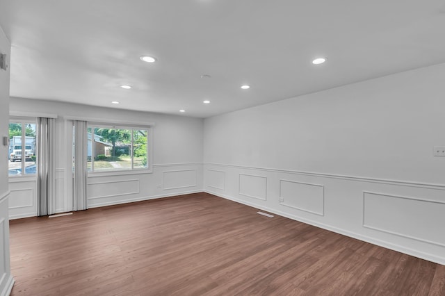 246 Gentry St, Park Forest, IL 60466 - empty room featuring recessed lighting, wood finished floors, a decorative wall, and wainscoting
