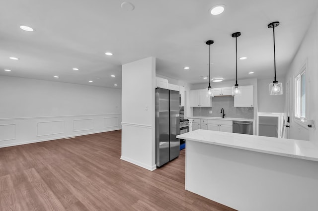 246 Gentry St, Park Forest, IL 60466 - kitchen featuring appliances with stainless steel finishes, white cabinetry, wood finished floors, recessed lighting, and decorative backsplash