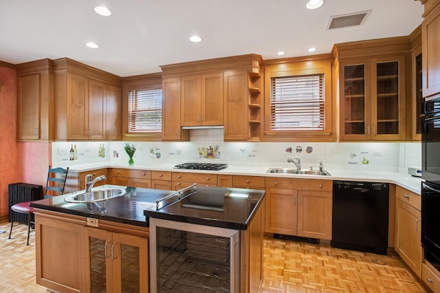 611 Lake Ave, Wilmette, IL 60091 - kitchen featuring black dishwasher, beverage cooler, stainless steel gas stovetop, a kitchen island, and decorative backsplash