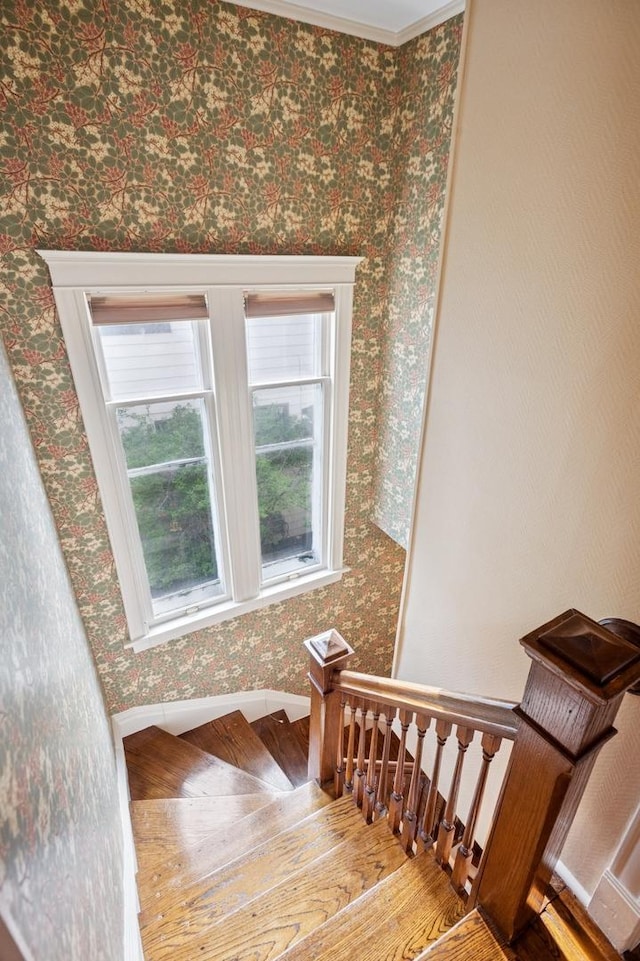 611 Lake Ave, Wilmette, IL 60091 - stairs featuring wood finished floors, wallpapered walls, and ornamental molding