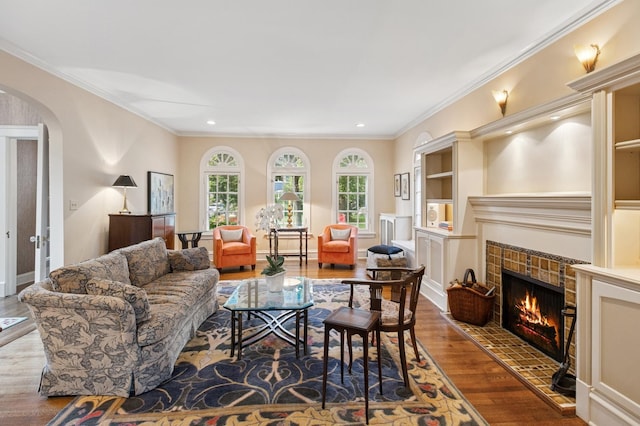 611 Lake Ave, Wilmette, IL 60091 - living area with wood finished floors, arched walkways, a tile fireplace, recessed lighting, and ornamental molding