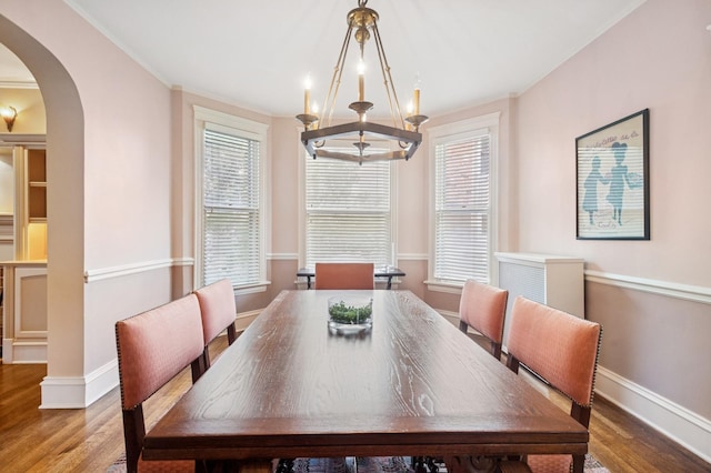 611 Lake Ave, Wilmette, IL 60091 - dining area featuring arched walkways, wood finished floors, plenty of natural light, and ornamental molding
