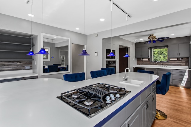 600 W Bloomingdale Rd, Itasca, IL 60143 - kitchen with black gas cooktop, ceiling fan, light countertops, recessed lighting, and oven