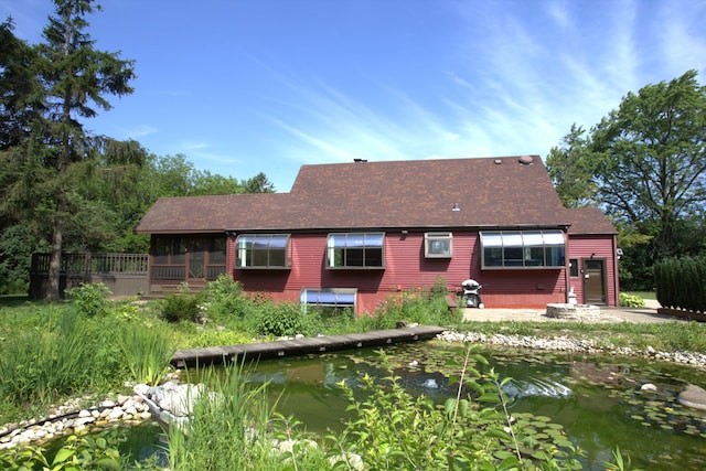 600 W Bloomingdale Rd, Itasca, IL 60143 - back of house featuring a shingled roof, a small pond, and a sunroom