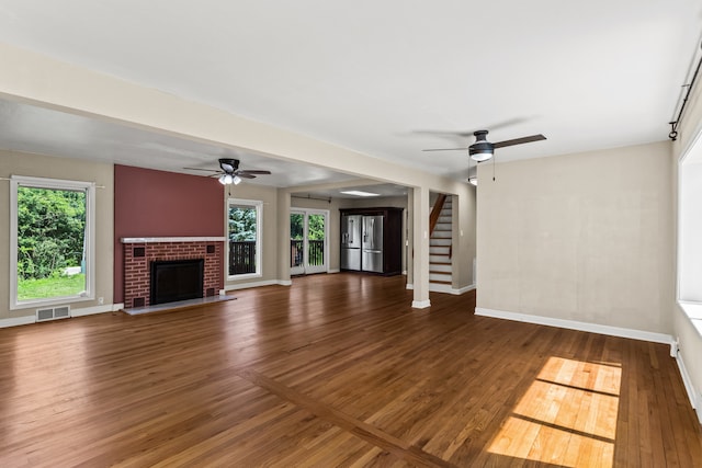 600 W Bloomingdale Rd, Itasca, IL 60143 - unfurnished living room with ceiling fan, wood finished floors, stairs, and a brick fireplace