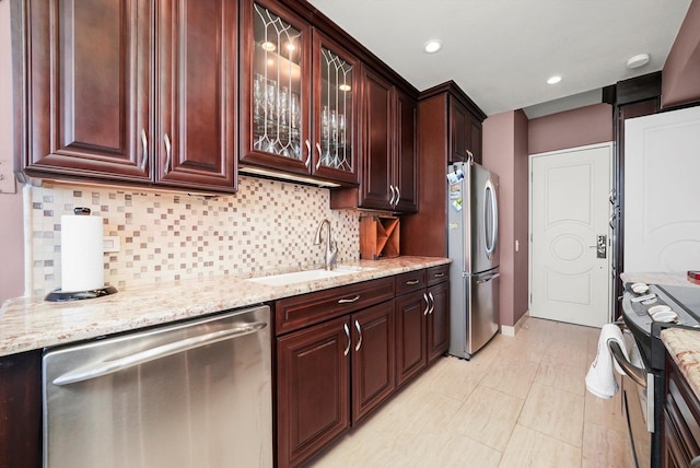 1300 N Lake Shore Dr Unit 10B, Chicago, IL 60610 - kitchen featuring stainless steel appliances, backsplash, light stone countertops, glass insert cabinets, and recessed lighting