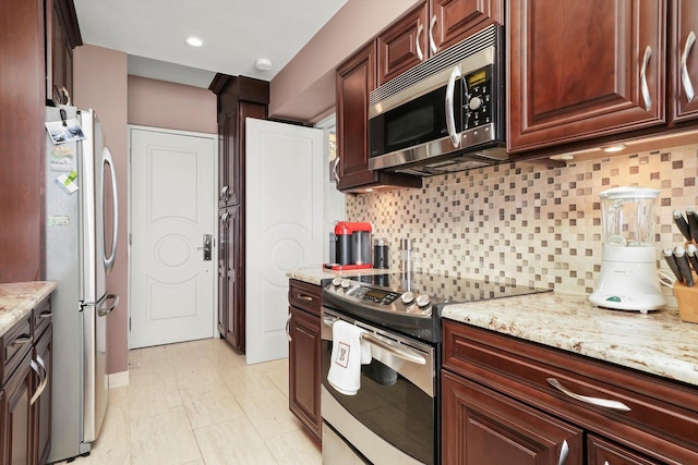 1300 N Lake Shore Dr Unit 10B, Chicago, IL 60610 - kitchen featuring appliances with stainless steel finishes, backsplash, and light stone counters