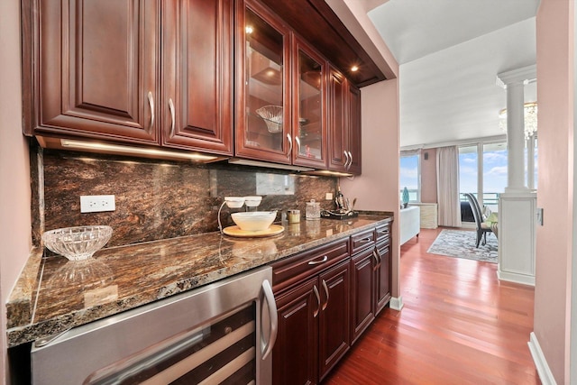 1300 N Lake Shore Dr Unit 10B, Chicago, IL 60610 - indoor bar with decorative columns, wine cooler, dark wood-style flooring, and backsplash