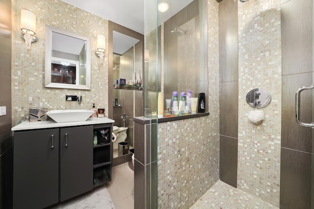 1300 N Lake Shore Dr Unit 10B, Chicago, IL 60610 - full bathroom with tile walls, a tile shower, vanity, and tile patterned flooring