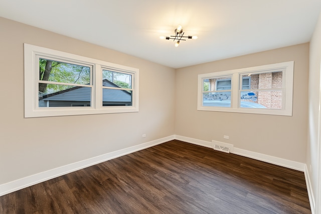 18506 Martin Ave, Homewood, IL 60430 - empty room with dark wood-style floors and a chandelier