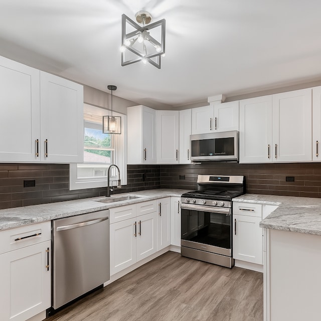 18506 Martin Ave, Homewood, IL 60430 - kitchen featuring stainless steel appliances, white cabinetry, light wood finished floors, and decorative backsplash