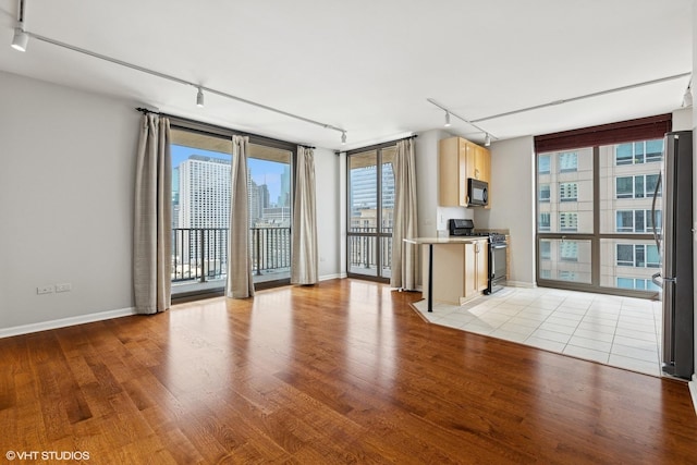 635 N Dearborn St Unit 2506, Chicago, IL 60654 - unfurnished living room with track lighting and light wood finished floors