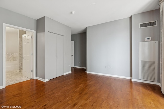 635 N Dearborn St Unit 2506, Chicago, IL 60654 - unfurnished bedroom with wood finished floors, a closet, and ensuite bathroom