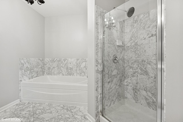 635 N Dearborn St Unit 2506, Chicago, IL 60654 - bathroom featuring a garden tub, a shower stall, marble look tiles, and a chandelier
