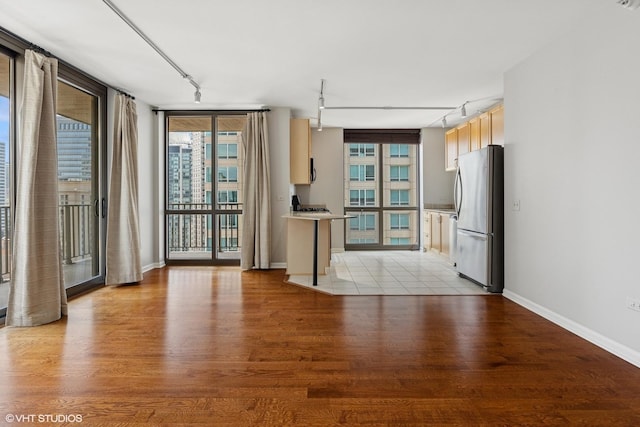 635 N Dearborn St Unit 2506, Chicago, IL 60654 - unfurnished living room featuring track lighting, light wood-style flooring, and plenty of natural light