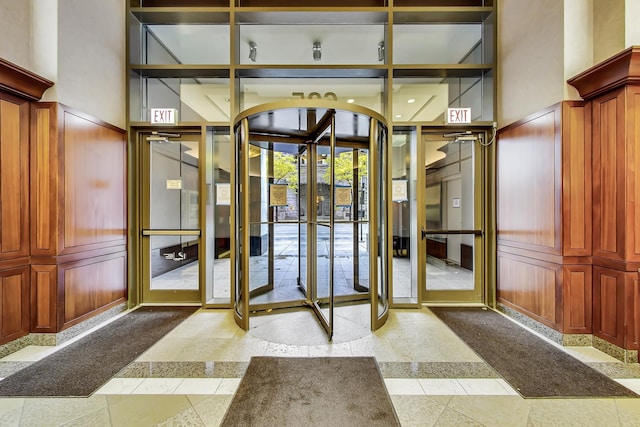 635 N Dearborn St Unit 2506, Chicago, IL 60654 - doorway to outside featuring inlaid floor details, a towering ceiling, french doors, and a decorative wall