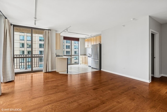 635 N Dearborn St Unit 2506, Chicago, IL 60654 - unfurnished living room featuring light wood-style floors and rail lighting
