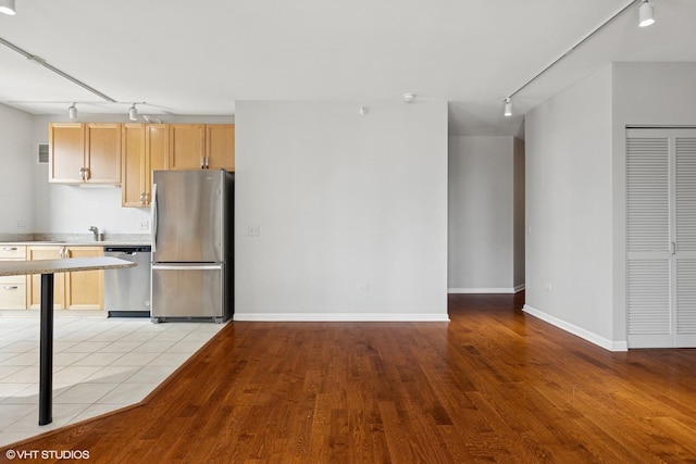 635 N Dearborn St Unit 2506, Chicago, IL 60654 - kitchen featuring rail lighting, stainless steel appliances, light wood finished floors, and light brown cabinetry
