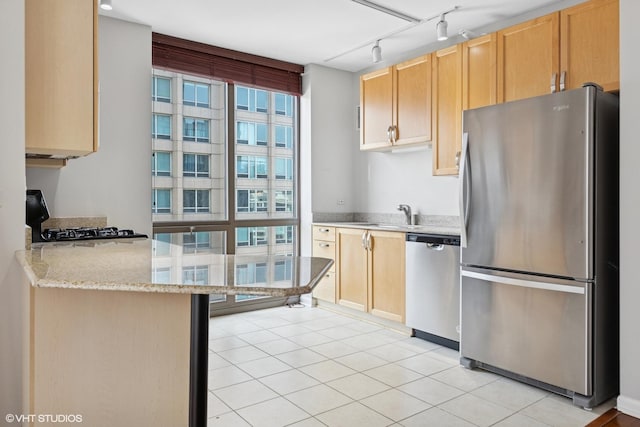 635 N Dearborn St Unit 2506, Chicago, IL 60654 - kitchen featuring appliances with stainless steel finishes, rail lighting, light brown cabinetry, and light stone countertops
