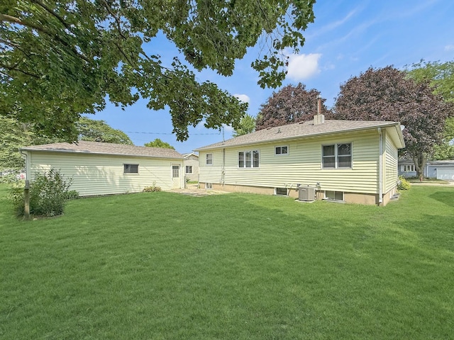 207 Southview Dr, Rochelle, IL 61068 - back of house featuring a yard and a chimney